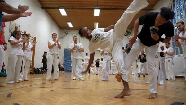 Capoeira movement: an aú (cartwheel) in the middle of the roda